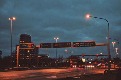 Illuminated road sign at night