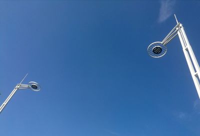 Low angle view of street light against blue sky