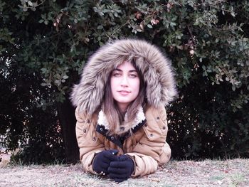 Portrait of teenage girl sitting in snow