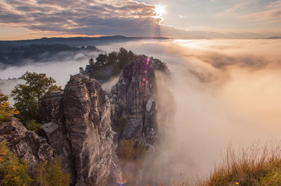 Panoramic view of rock formation against sky during sunset