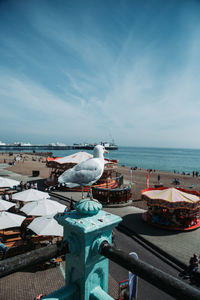 High angle view of seagulls by sea against sky