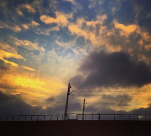 Scenic view of sea against cloudy sky at sunset