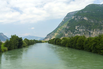 Scenic view of lake and mountains against sky