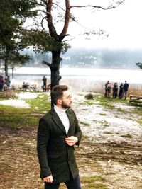 Young man standing on landscape during winter