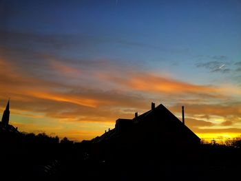 Buildings against sky at sunset