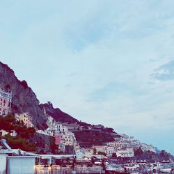 Low angle view of buildings in town against sky