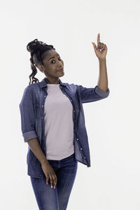 Young woman looking away against white background