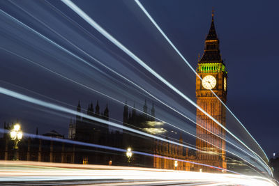 Low angle view of illuminated tower bridge at night