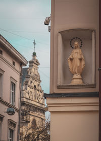 Low angle view of statue against building