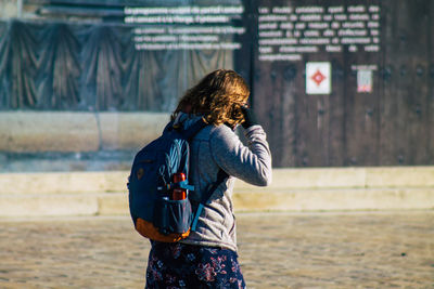 Rear view of woman standing outdoors