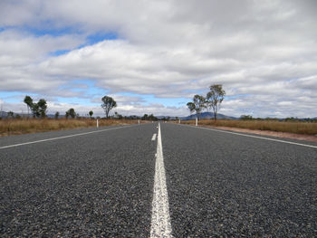 Empty road along trees