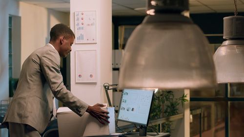 Side view of man using digital tablet in office