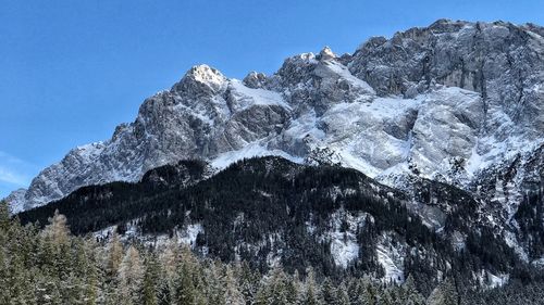 Low angle view of snow on mountain against sky