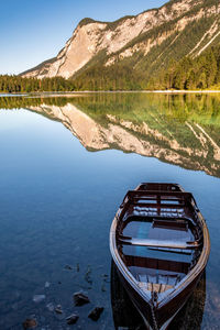 Scenic view of lake by mountains against sky