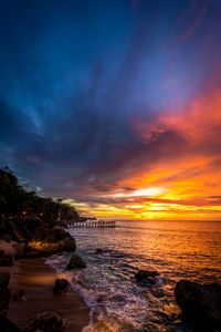 Scenic view of beach against sky during sunset