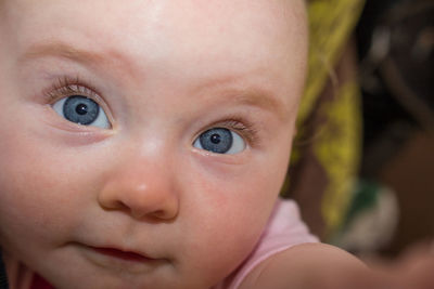 Close-up portrait of cute baby girl with gray eyes