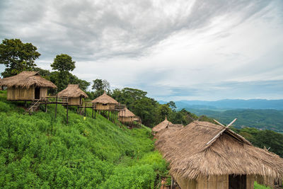 Houses amidst trees and buildings against sky
