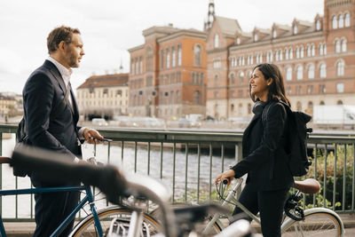 Full length of man with bicycle in city