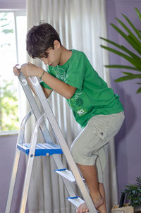 Portrait of a child climbing a stainless steel ladder. skill at home. 