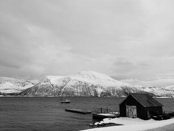 Houses by snowcapped mountains against sky