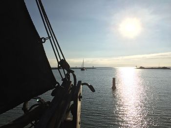 Silhouette ship sailing on sea against sky during sunset