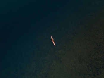 High angle view of helicopter flying over sea