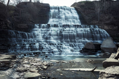 Water splashing on rocks by river