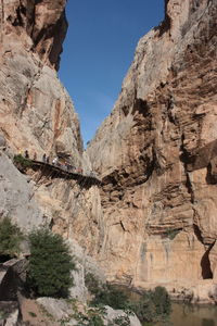 Low angle view of rocky mountains against clear sky
