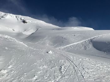 Scenic view of snow covered mountain against sky