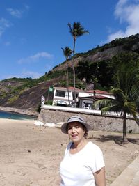 Senior woman standing at beach