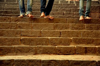 Low section of people walking on staircase