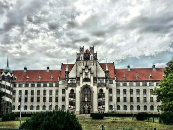 Buildings against cloudy sky