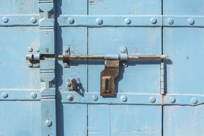 Closeup of antique blue door in india style in sunlight