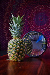Close-up of a ananas on table with mirror 