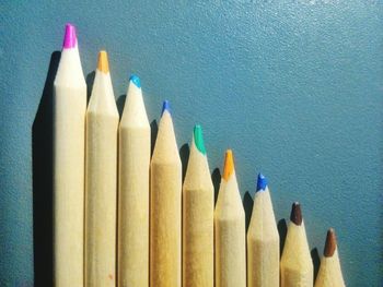 Close-up of colored pencils on blue table