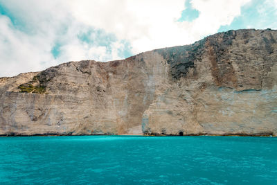 Scenic view of sea and mountains against sky