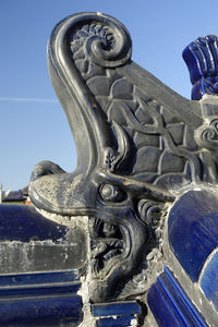 Low angle view of statue against blue sky