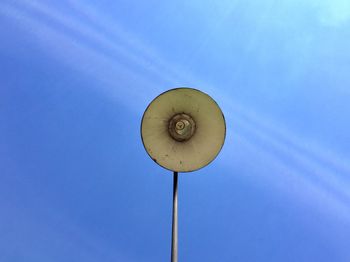 Low angle view of street light against blue sky