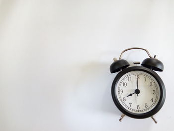 Directly above shot of alarm clock on gray background