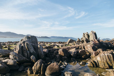 Rocks on shore against sky