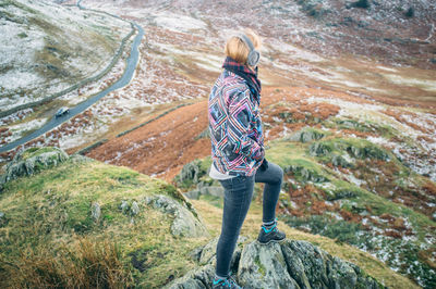 Full length of woman standing on mountain