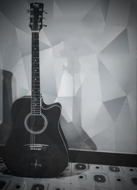 High angle view of guitar on table against wall