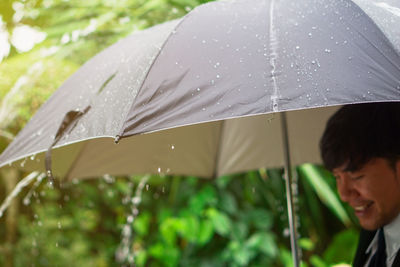 Man with umbrella during rainfall