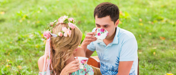 Portrait of friends drinking water on plant