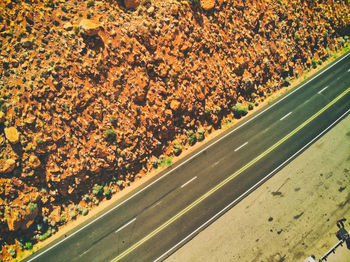 High angle view of road amidst trees on field