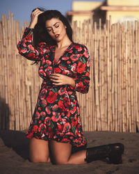 Young woman looking away while standing outdoors