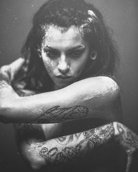 Close-up portrait of young woman in water