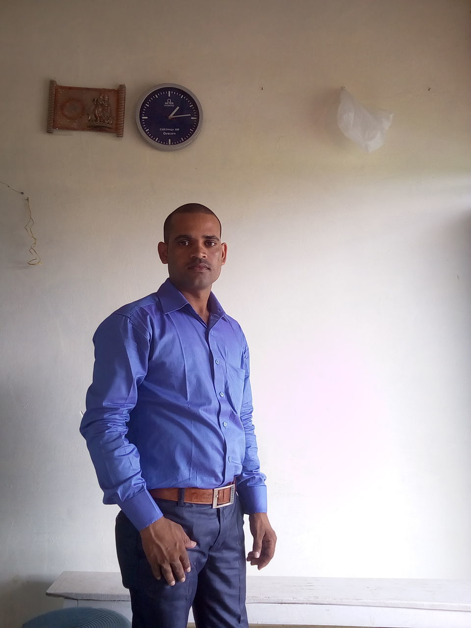 PORTRAIT OF YOUNG MAN STANDING ON WALL