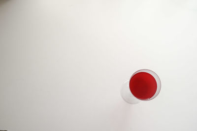 Close-up of red object over white background