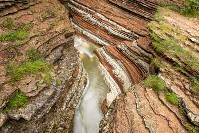 High angle view of river flowing amidst rock formations